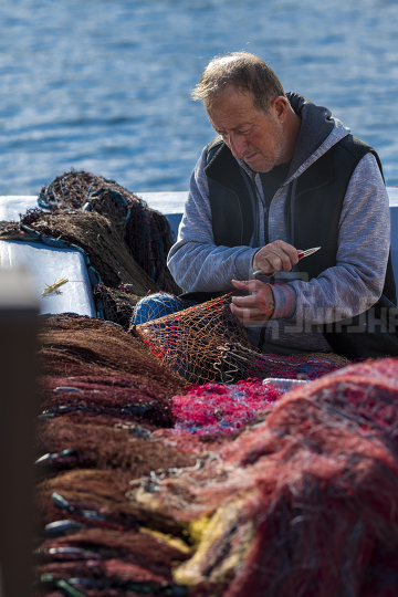 Fisherman mending nets