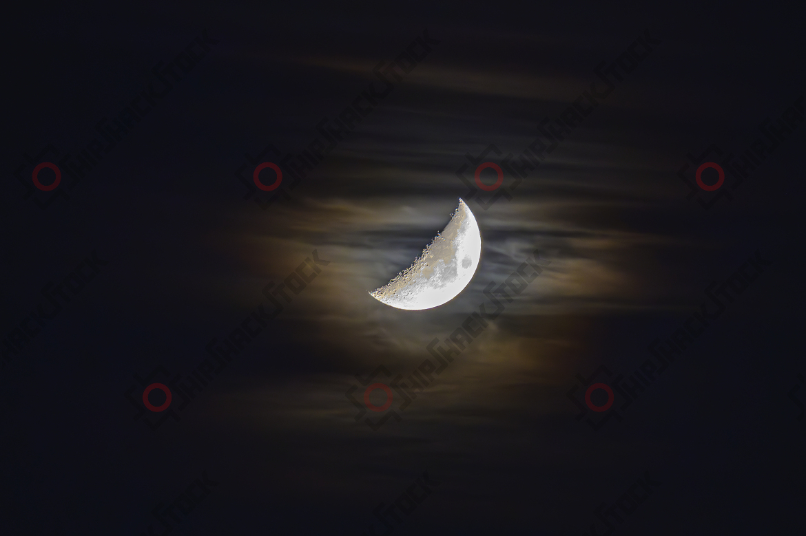 Half moon behind the clouds